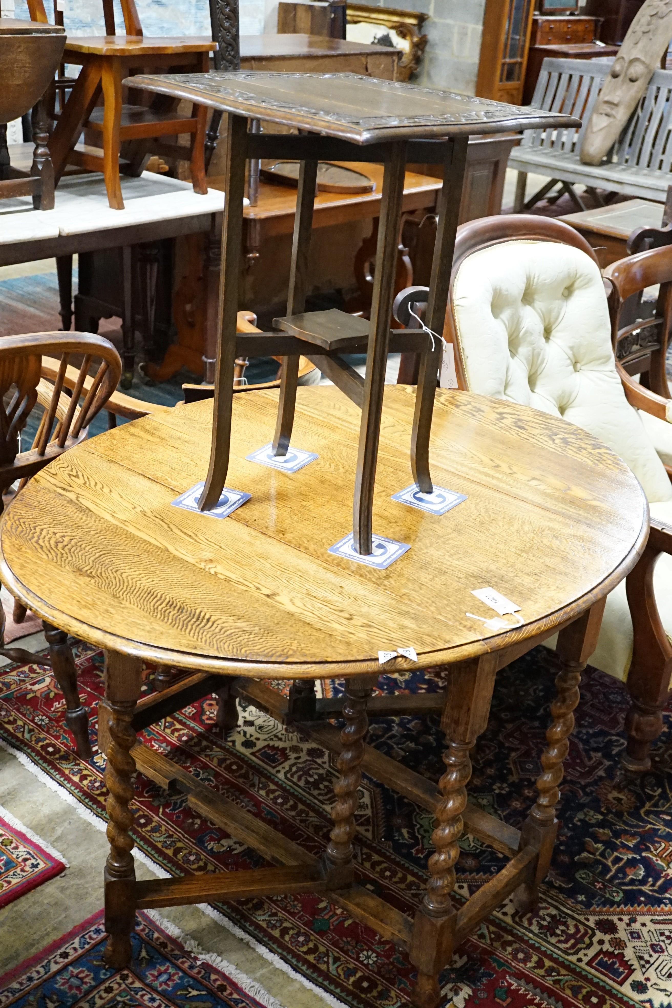 A 1920's oak gateleg table opens to 117 x 90cm and an Edwardian carved oak folding occasional table, width 45cm